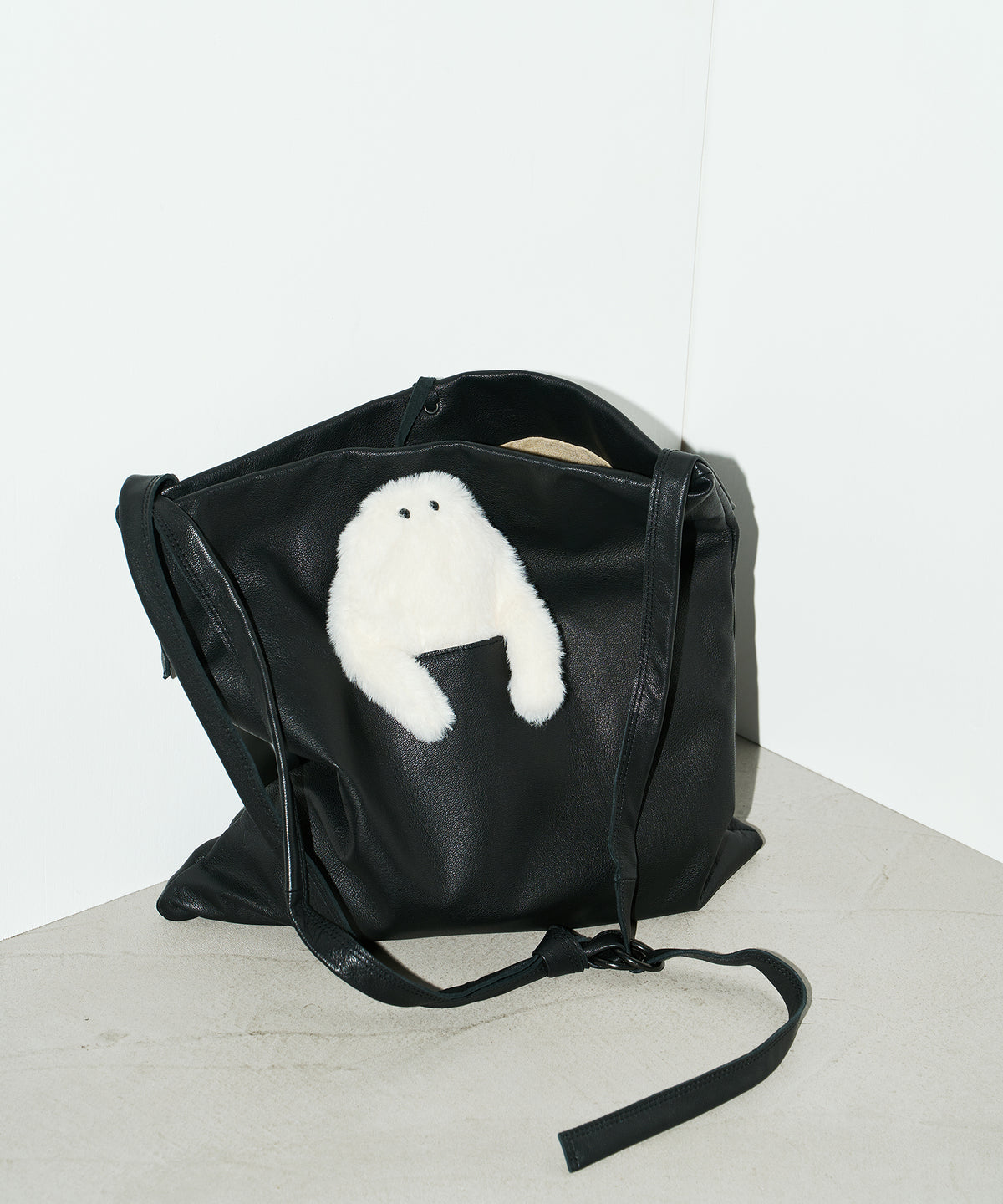 It features a dedicated outer pocket designed to hold a plush toy and is available as a limited-edition set with an Opantsu-kun plush pouch.